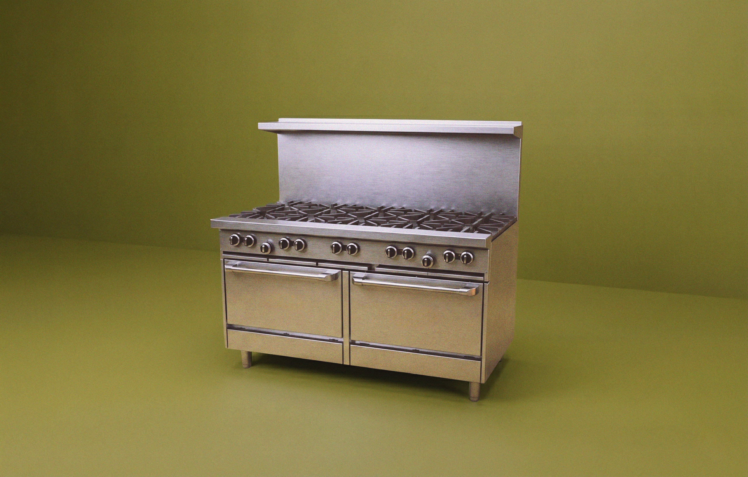 Aerial view of kitchen range with blue flames shot on a bright yellow studio background.