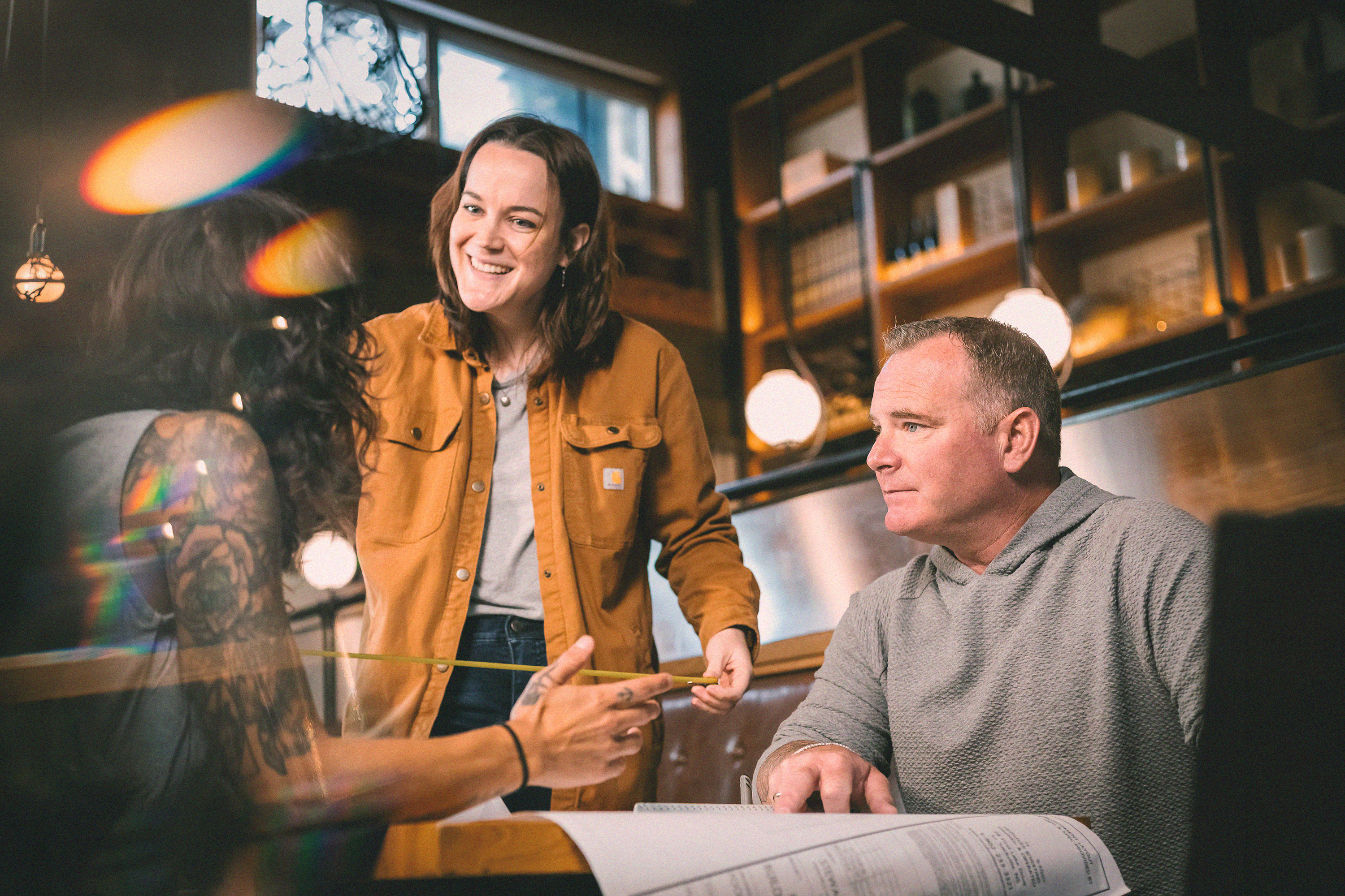 Two RYCO Designers reviewing plans with a client 